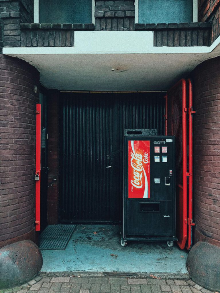 Vending machine beside black wooden door